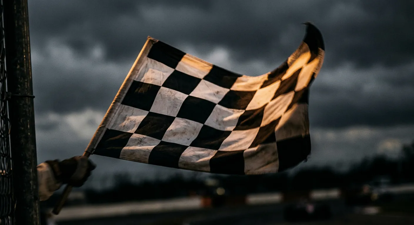 Checkered flag waving against a dark sky